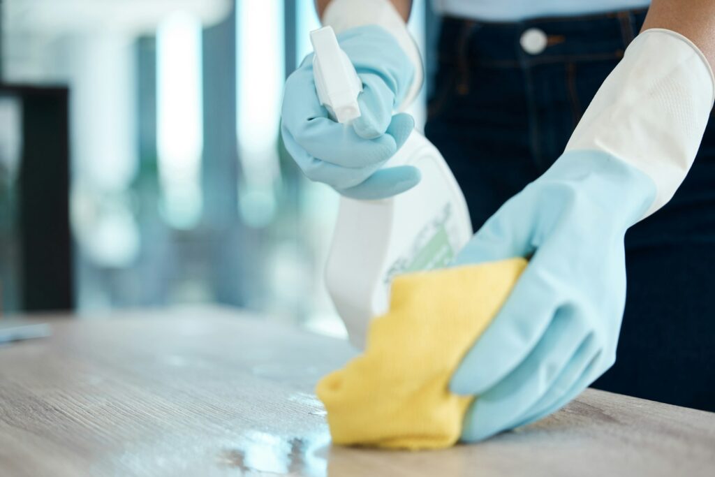 Cleaning, spray bottle and hygiene with woman with gloves for housekeeping, service or disinfectant